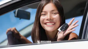 a teen driver smiling